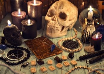 Black magic removal process with human skulls on the table.