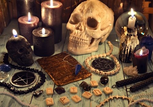 Black magic removal Black magic removal process with human skulls on the table.